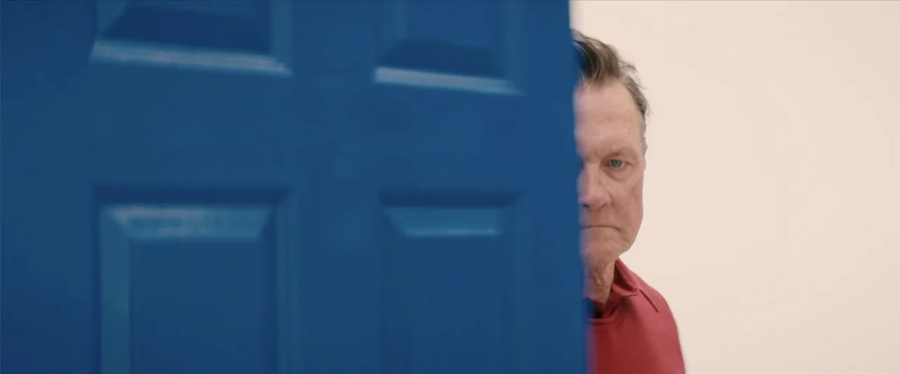 Equation of Love and Tone Deafness (2015) movie still: closeup — An interior space features a bright blue door occupying the left side of the frame.…