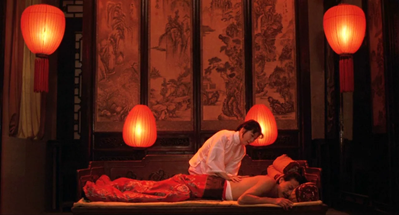 Raise The Red Lantern movie still: medium — A traditional room features intricate wood paneled walls decorated with landscape paintings. Red paper…
