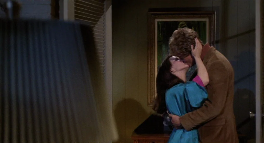 The Trip (1967) movie still: medium — A dimly lit room with paneled walls features a landscape painting hanging above furniture. A man in a brown…