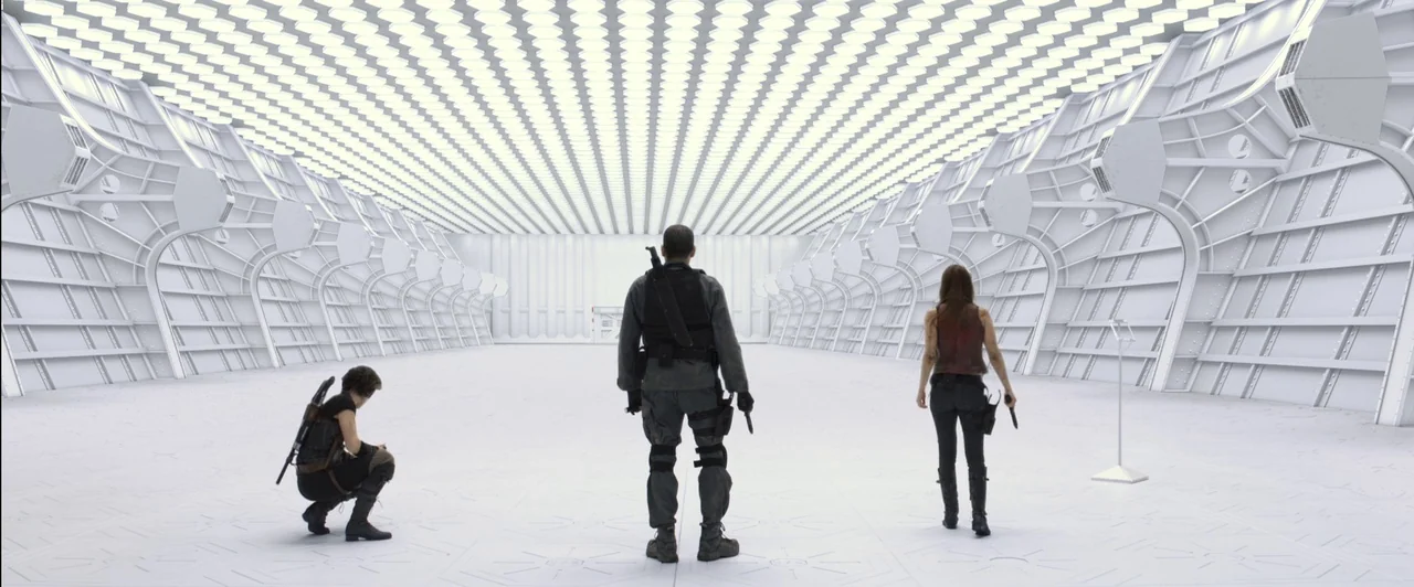 Resident Evil: Afterlife (2010) movie still: wide — A massive, minimalist, white, high-ceilinged chamber with geometric wall ribbing and recessed…