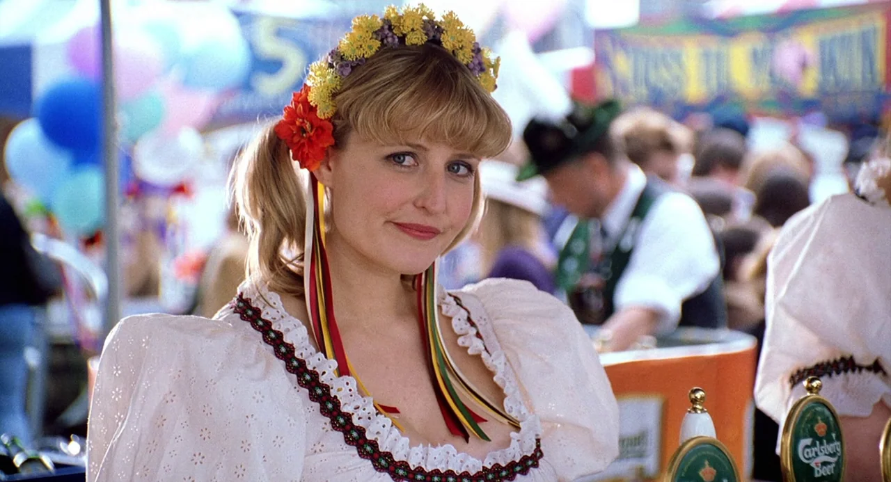 The Weather Man (2005) movie still: medium — An outdoor fair setting features blurred crowds and booths in the background. A young woman in a…