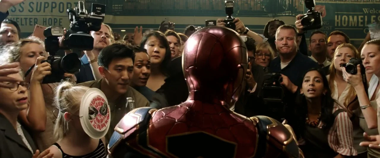Spider-Man: Far From Home (2019) movie still: medium — A crowded indoor space filled with journalists holding professional cameras and flashes. A…