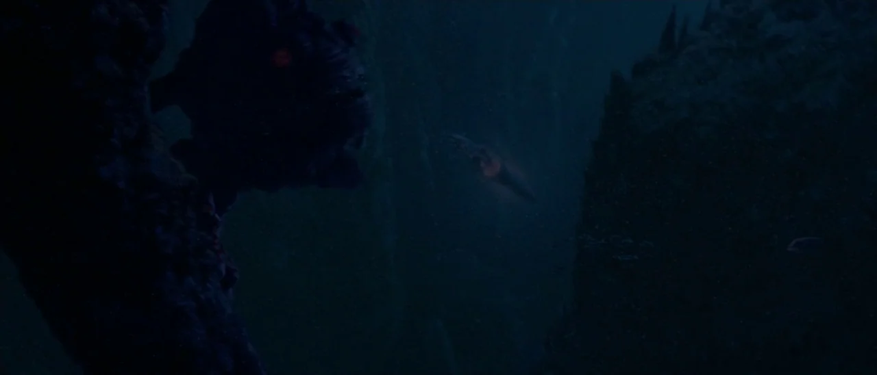 Star Wars: Episode I – The Phantom Menace (1999) movie still: wide — Deep underwater abyss with dark silhouettes of rock formations visible. Two…