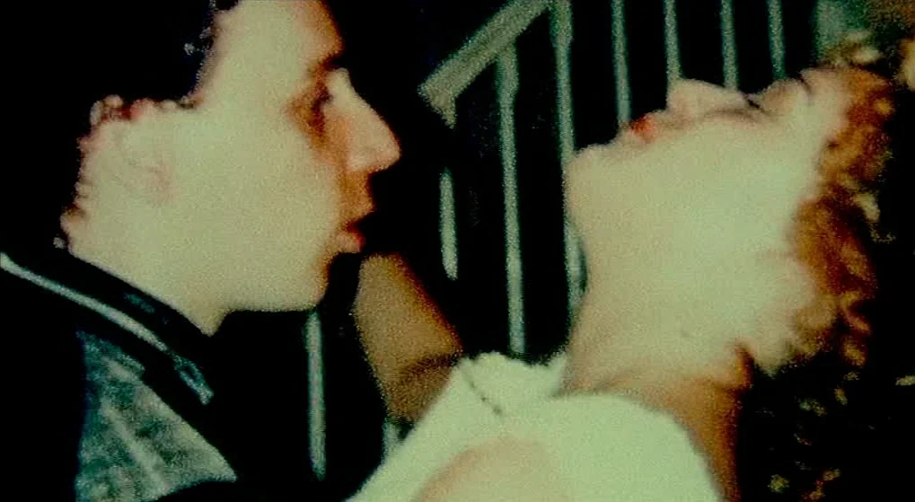 Julien Donkey Boy (1999) movie still: closeup — A dark stairwell with a metal banister visible in the background shadow. A man and a woman stand…