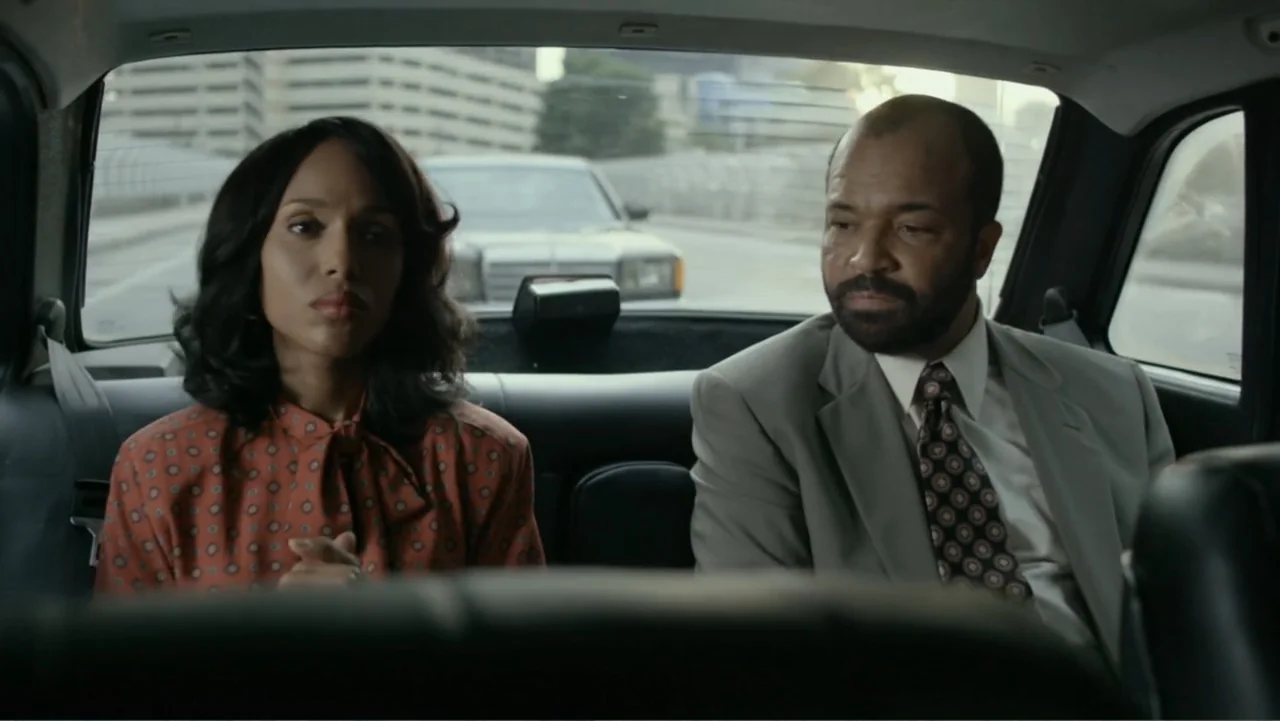 Confirmation (2016) movie still: medium — The interior of a car features two people sitting in the leather backseat. A woman and a man look forward…