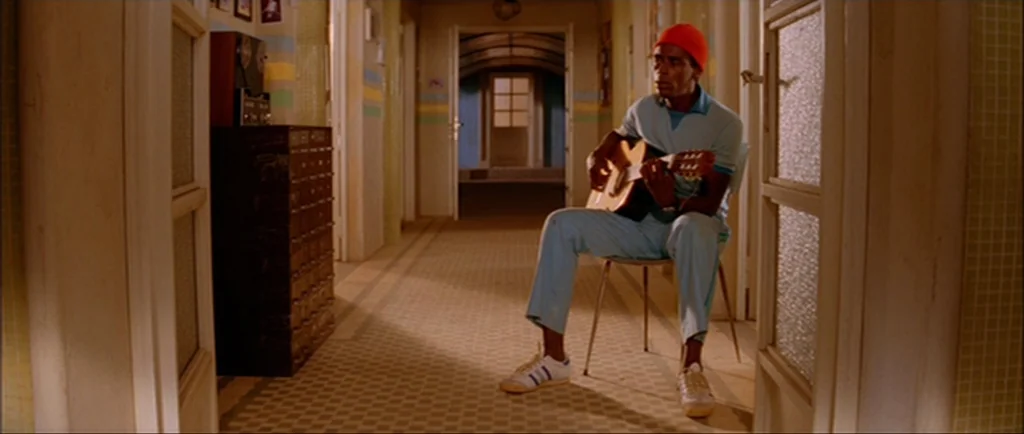 The Life Aquatic With Steve Zissou (2004) movie still: fullbody — An apartment building hallway features light-colored walls with horizontal…