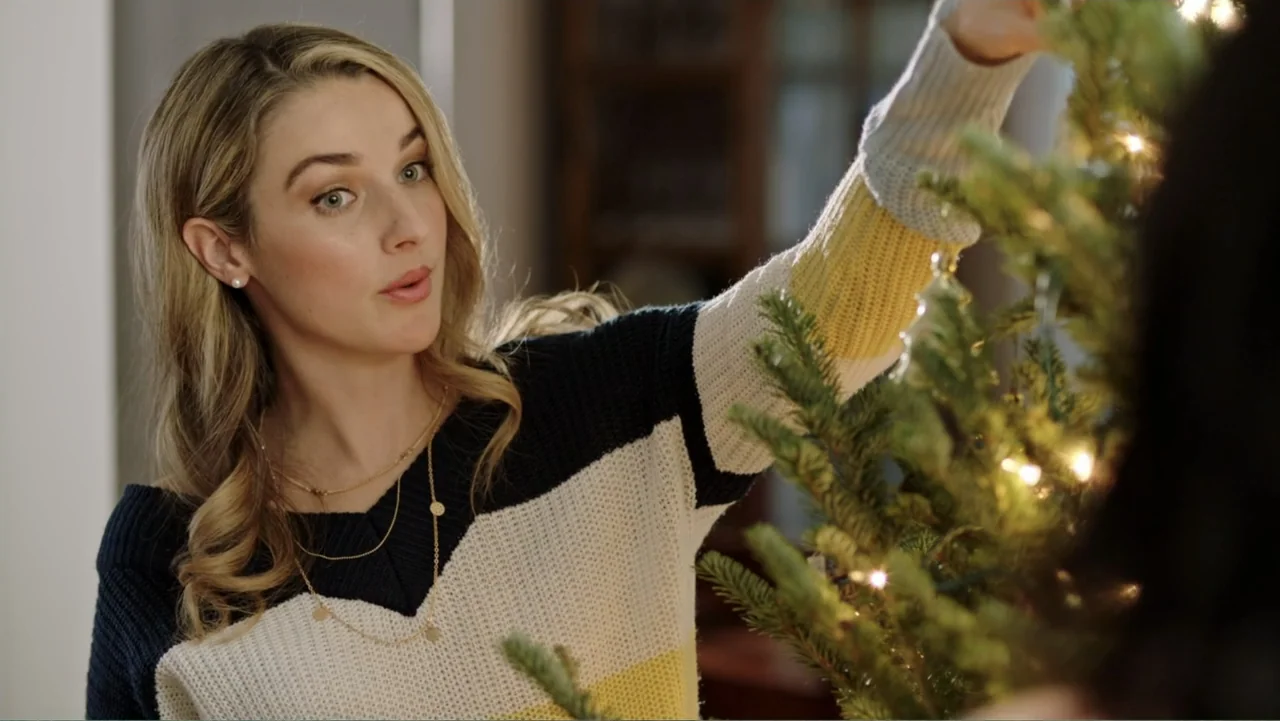 Ghosts of Christmas Past (2021) movie still: medium — An interior living room scene featuring a decorated Christmas tree with warm fairy lights. A…