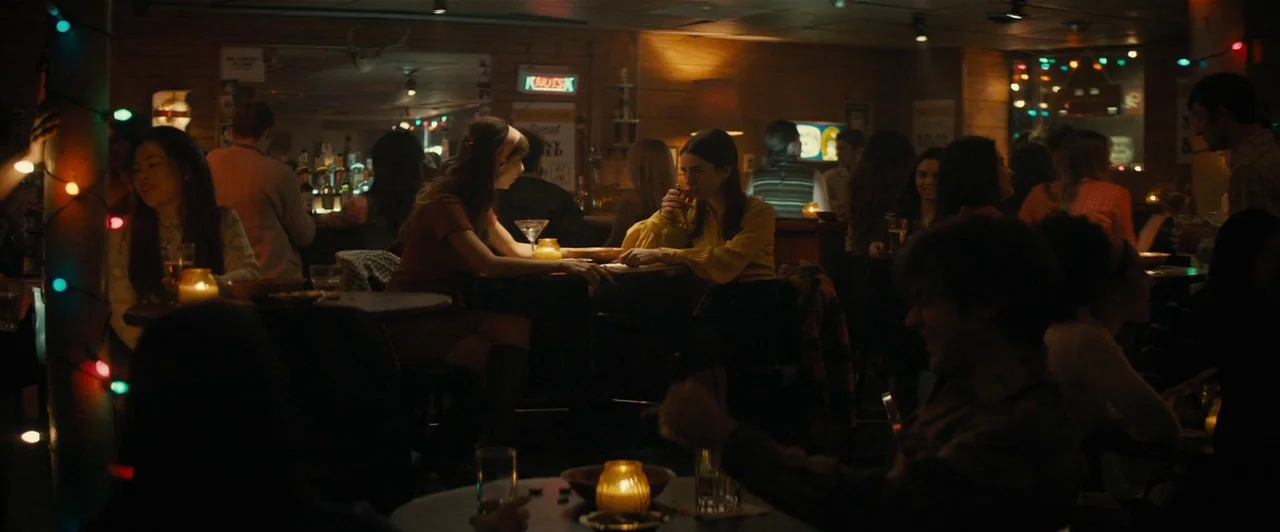 Extremely Wicked, Shockingly Evil and Vile (2019) movie still: wide — A dimly lit 1970s bar features wooden walls decorated with festive…