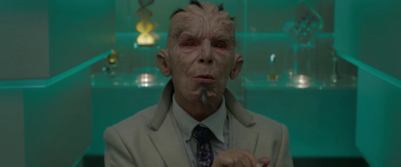 Guardians of the Galaxy (2014) movie still: medium — A sterile gallery room features glowing teal panels and glass display cases containing…