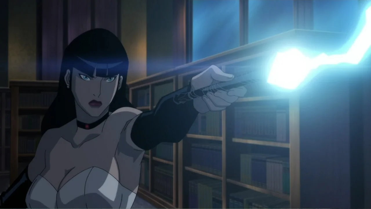 Justice League Dark (2017) movie still: medium — A dimly lit room filled with tall wooden shelves of books. A woman extends a glowing baton towards…
