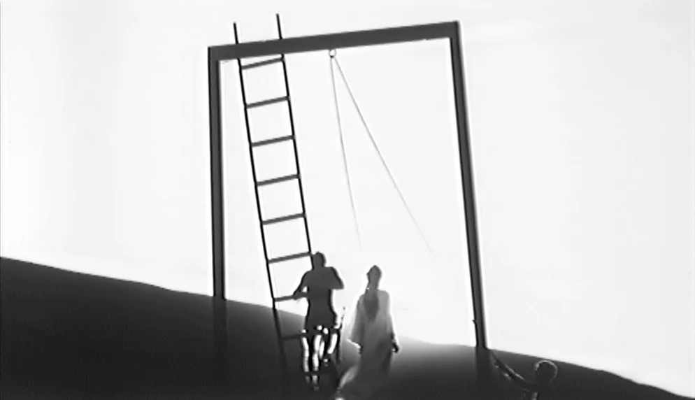 The Plea (1968) movie still: wide — An abstract, minimalist space is defined by an oversized rectangular metal frame and ladder. Two figures stand…