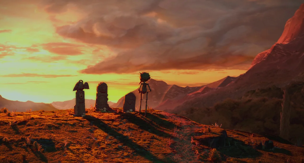 Guillermo del Toro’s Pinocchio (2022) movie still: wide — A grassy hill holds three gravestones at sunset under a dramatic, cloudy sky. A small…