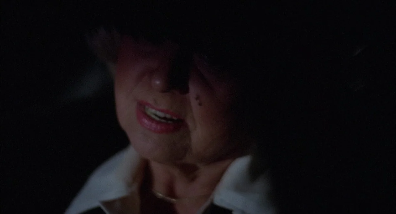 Opening Night (1977) movie still: closeup — A woman's face is partially illuminated against an entirely black, nondescript background. The subject…