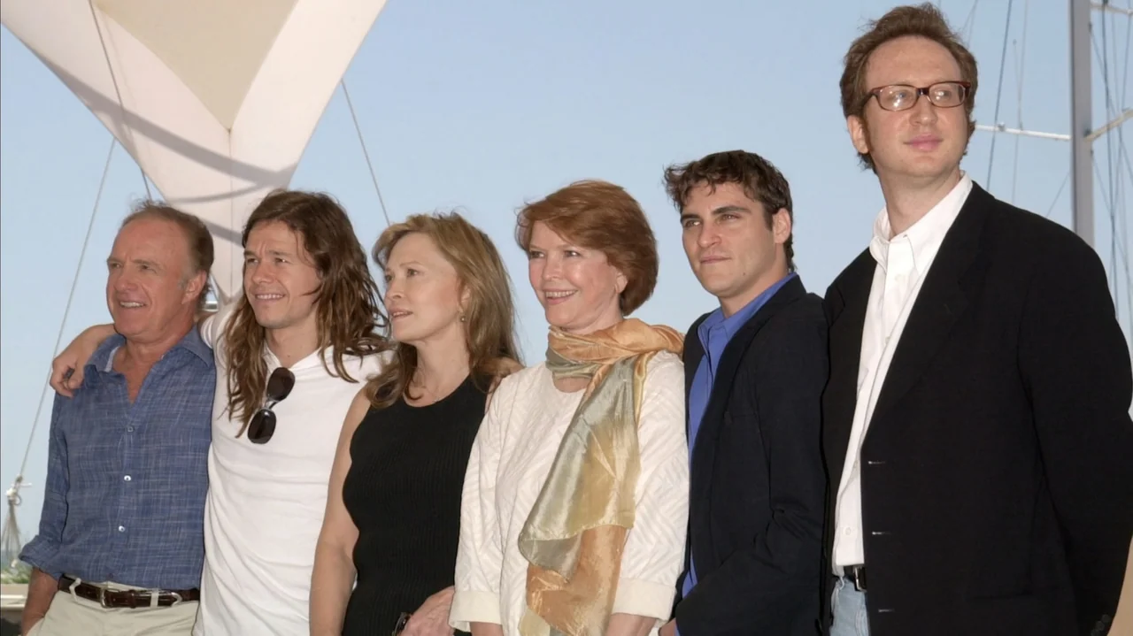 Faye (2024) movie still: fullbody — Six individuals stand together in a horizontal line against a bright, clear blue sky. They pose side-by-side…