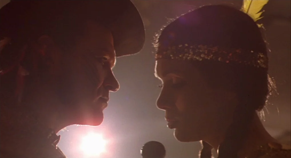 Breakfast On Pluto (2005) movie still: medium — A performance area with a microphone stands between a man and a woman. The couple faces each other…