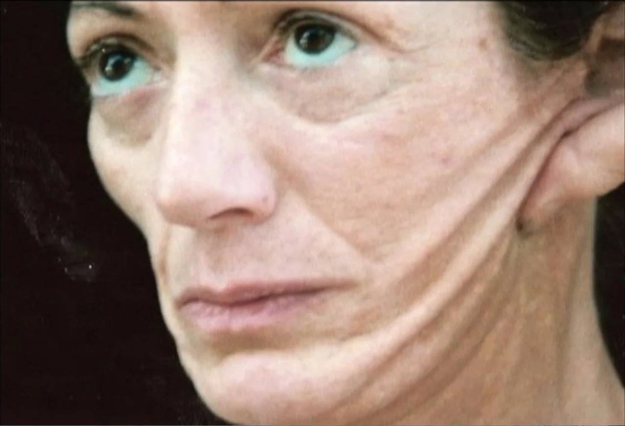 Plastic Disasters (2006) movie still: closeup — An unidentified dark interior space provides a neutral, featureless background for the subject. A…