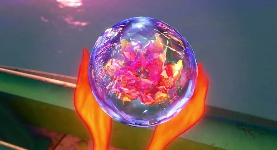 Elemental (2023) movie still: closeup — A crystalline sphere with a glowing flower inside floats over dark water at night. Two orange, flame-like…