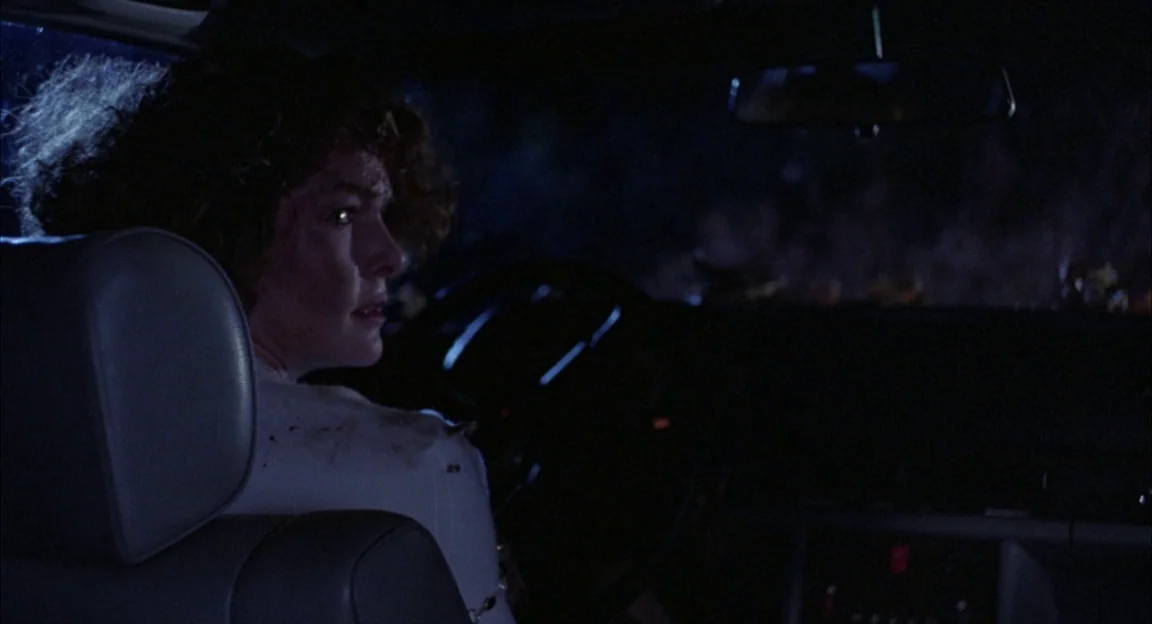 Creepshow 2 (1987) movie still: medium — The interior of a late 20th-century vehicle at night with dark surroundings outside. A woman sits in the…