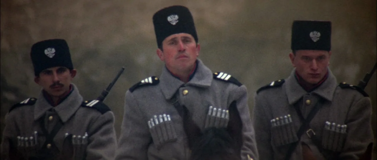 Fiddler On The Roof (1971) movie still: medium — Three soldiers on horseback wear grey 19th-century military uniforms with cartridge holders across…