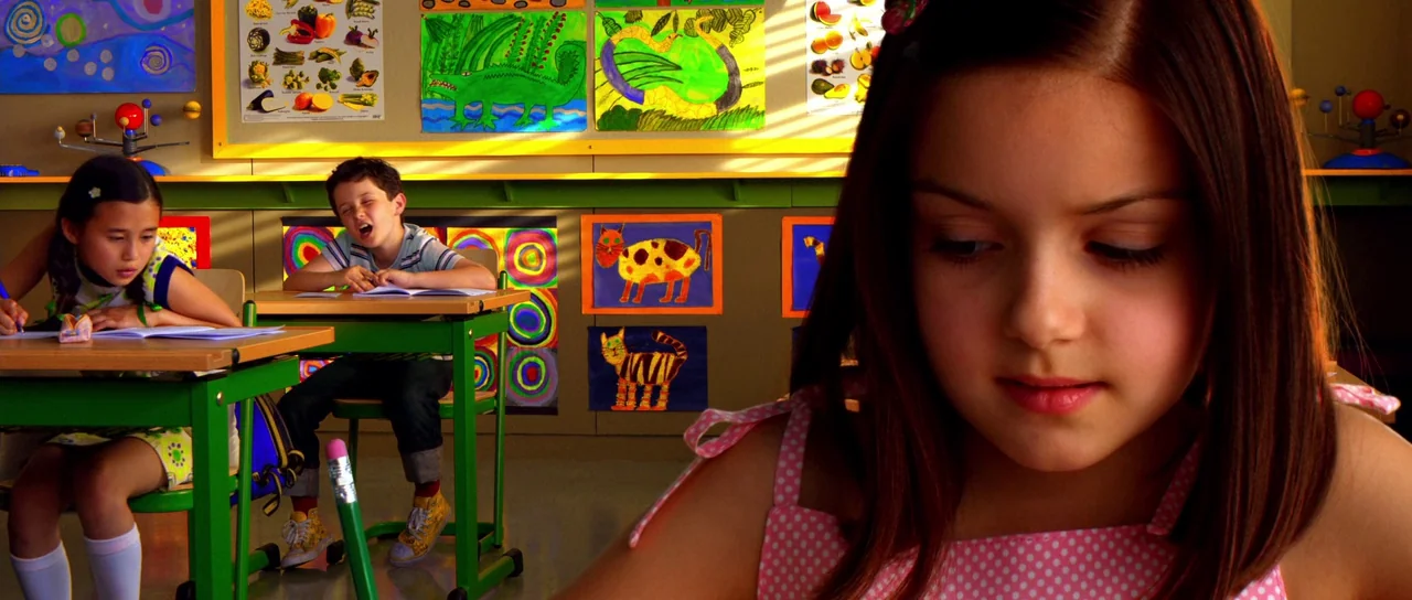 Speed Racer (2008) movie still: closeup — A bright school classroom decorated with colorful student artwork and diagrams on the walls. A young girl…