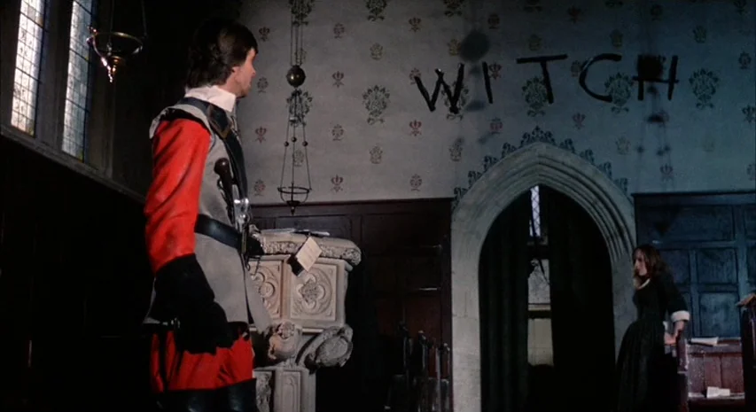 Witchfinder General (1968) movie still: medium — A stone church interior features patterned wallpaper with the word WITCH painted in black ink. A…