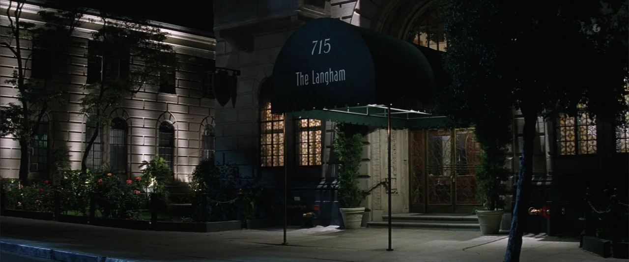 License to Wed (2007) movie still: establishing — A stone building entrance at night features an arched doorway and a dark awning. The facade…