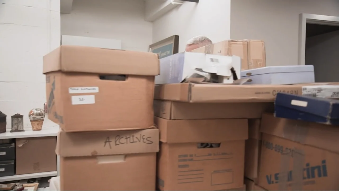 Nothing Left Unsaid: Gloria Vanderbilt & Anderson Cooper (2016) movie still: medium — A cluttered storage room contains high stacks of cardboard…