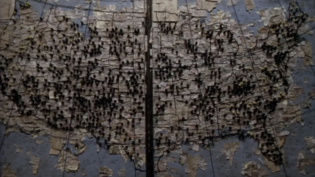 Suspect Zero (2004) movie still: wide — A large map of the United States is constructed from dozens of small, overlapping paper fragments. Numerous…