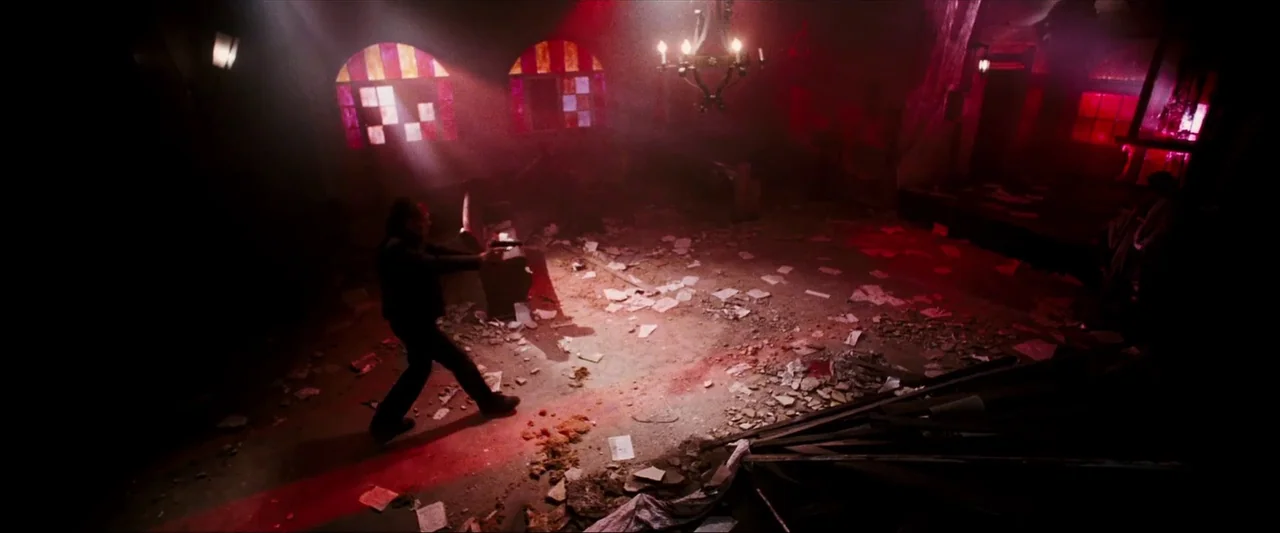 Death Sentence (2007) movie still: wide — An interior space covered in scattered papers and stone debris features arched window openings. A man…
