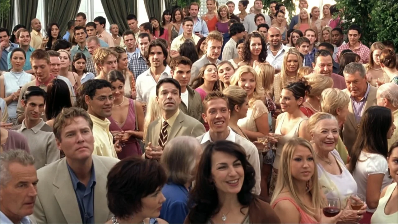 White Chicks (2004) movie still: wide — A crowded indoor party space filled with guests in formal and casual attire. People stand close together in…