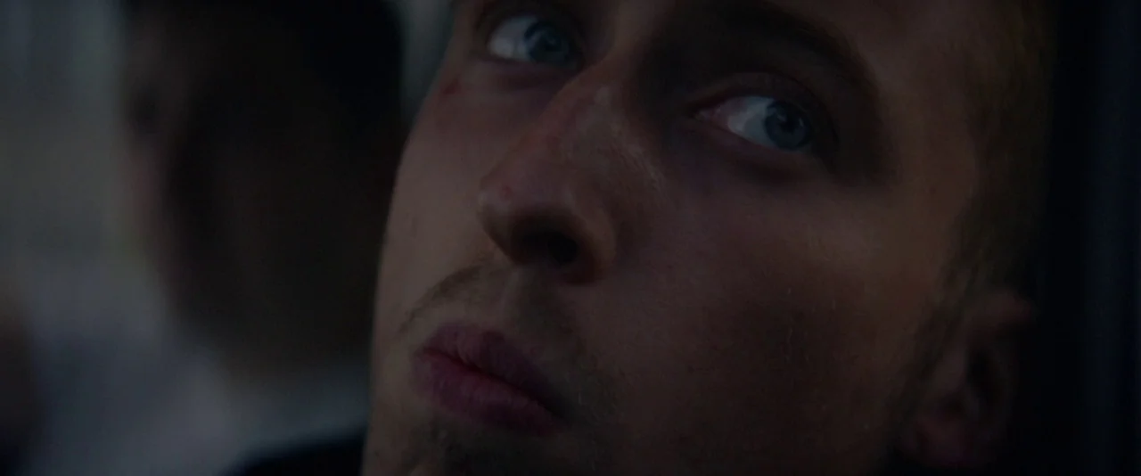 Kissing Candice (2017) movie still: closeup — A dark vehicle interior with the passenger side window revealing faint motion blur outside. A man in…