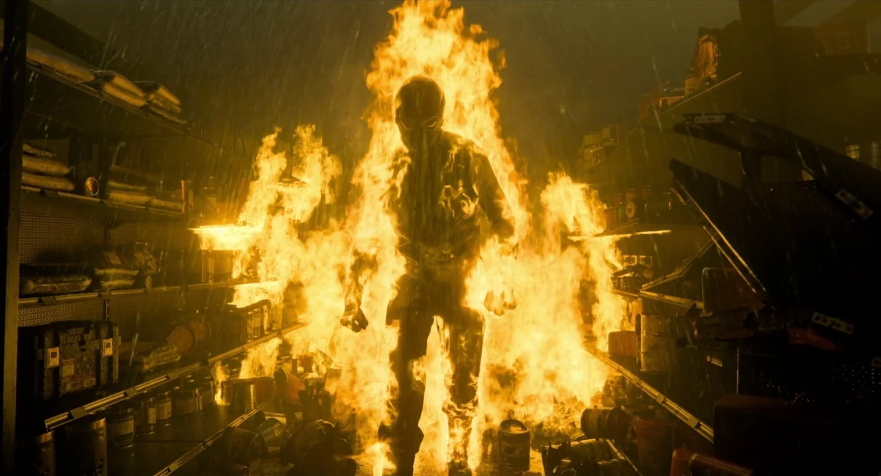 Gemini Man (2019) movie still: fullbody — A retail store aisle with shelves stocked with various products is consumed by fire. A single silhouetted…