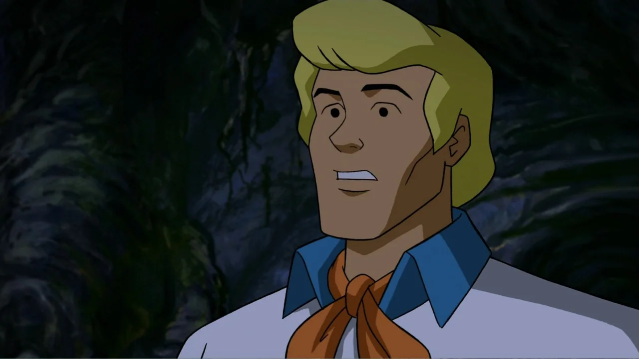 Scooby-Doo! Return to Zombie Island (2019) movie still: closeup — A dark, textured stone wall forms the backdrop for a stylized animated character.…
