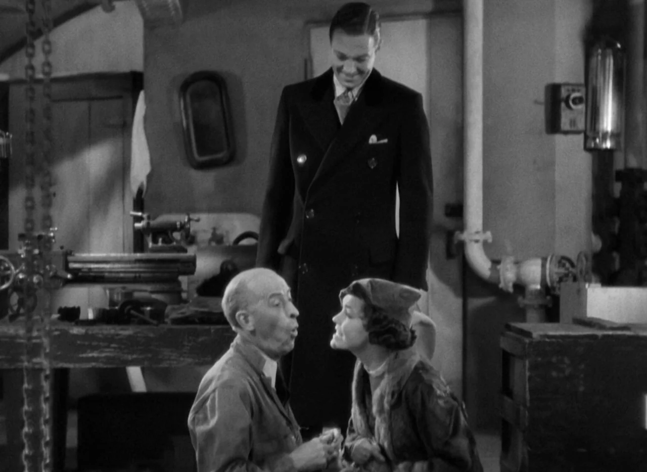 The Thin Man (1934) movie still: medium — A workshop interior featuring heavy machinery, metal pipes, and a workbench with various tools. Three…