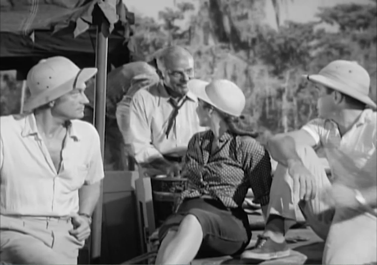 Creature from the Black Lagoon (1954) movie still: medium — A group of people wearing pith helmets sits on the deck of a boat. The background shows…