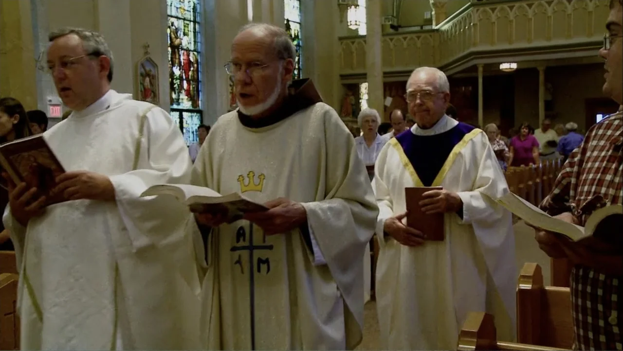 12th & Delaware (2010) movie still: medium — A church interior features stained glass windows and wooden pews filled with congregants. Three men in…