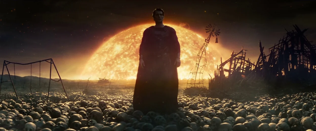 Man Of Steel (2013) movie still: fullbody — A desolate wasteland covered in thousands of human skulls beneath a giant burning sun. A lone caped…