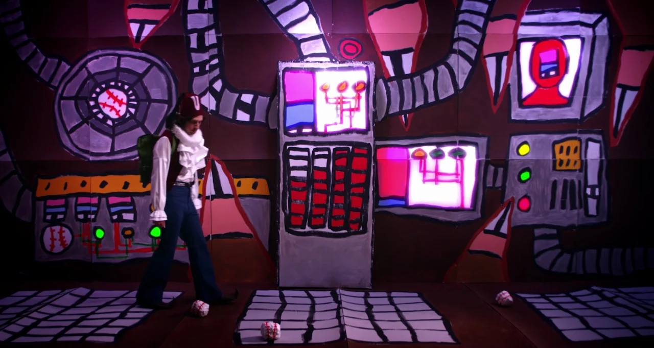 Adam Green’s Aladdin (2016) movie still: fullbody — A theatrical set features a flat hand-painted backdrop representing a complex electronic control…