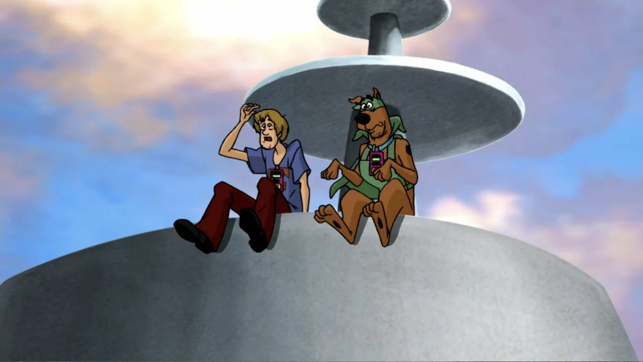 Scooby-Doo! Mask of the Blue Falcon (2012) movie still: medium — A high, curved structure stands against a pale blue and orange sunset sky. A young…