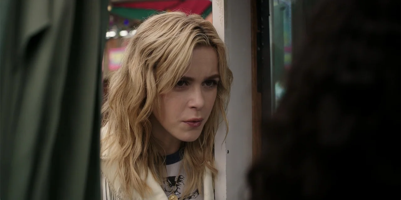 Totally Killer (2023) movie still: closeup — A close view inside a tent with fabric walls and light filtering in. A blonde woman in a white jacket…