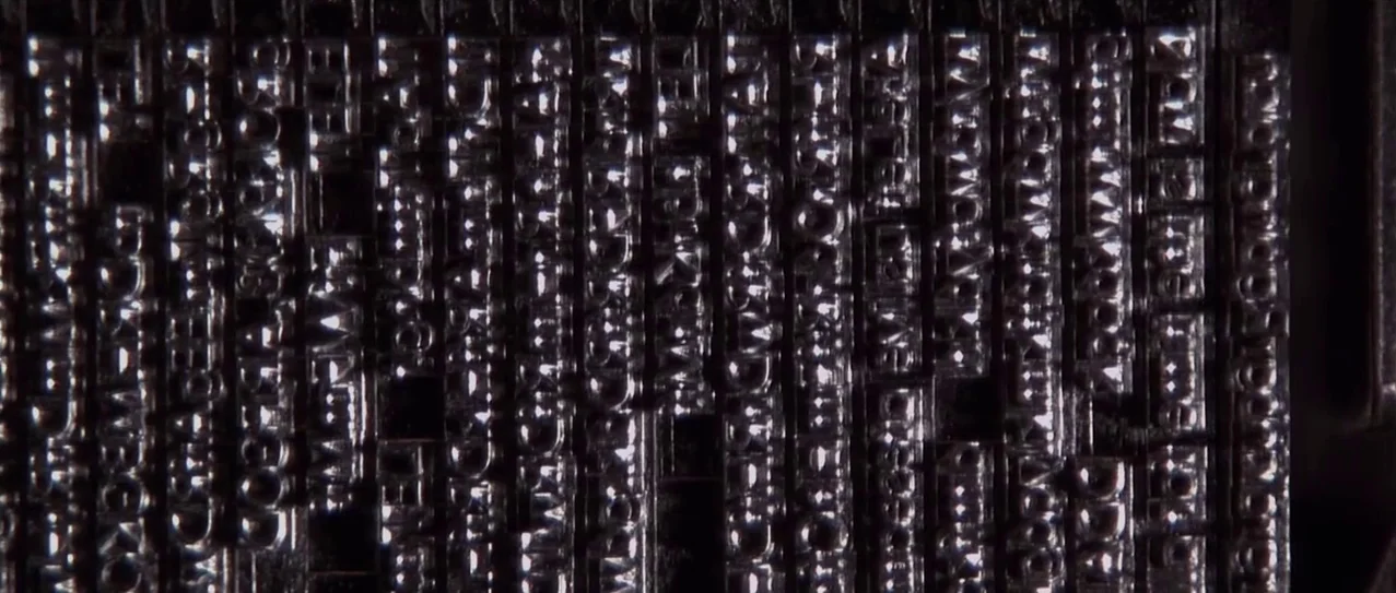 Snow Falling on Cedars (1999) movie still: closeup — A close view of arranged metal printing type blocks set in a galley tray. The raised letters…