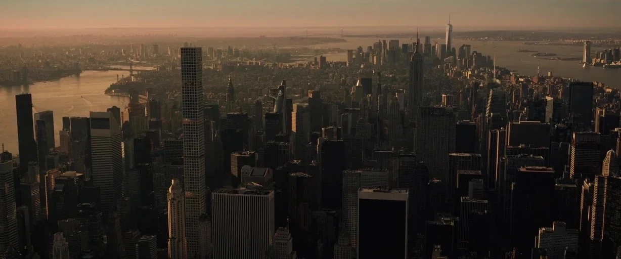 Doctor Strange (2016) movie still: establishing — A sprawling aerial view of the New York City skyline at sunset. Dense clusters of skyscrapers…