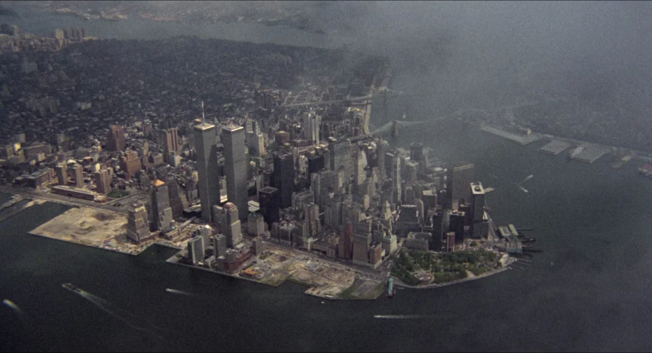 The Prince of Tides (1991) movie still: establishing — An aerial view of the lower Manhattan skyline features the World Trade Center towers. Waters…