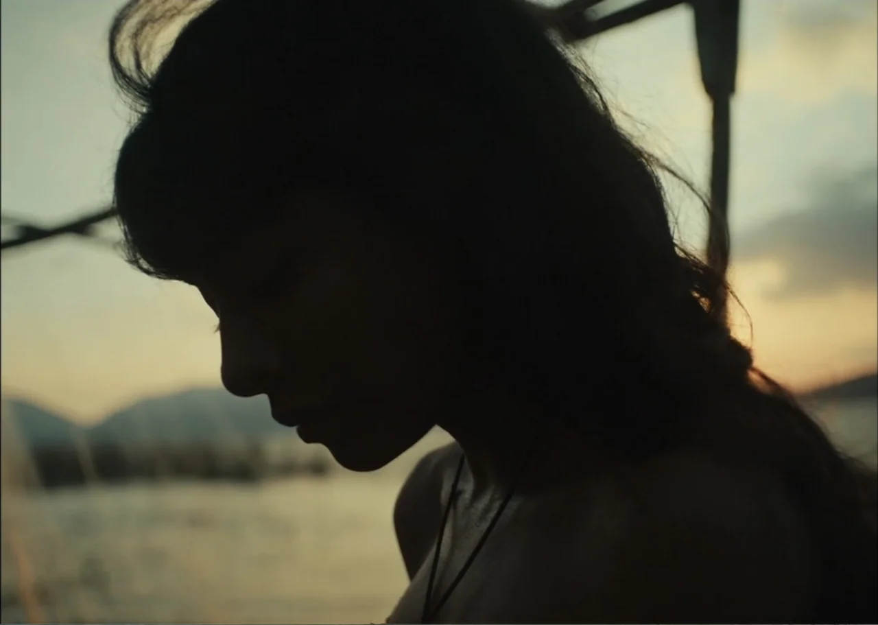 A Fisherman's Tale (1976) movie still: closeup — A lakeshore at sunset features a silhouette of a person against the water. The individual faces the…
