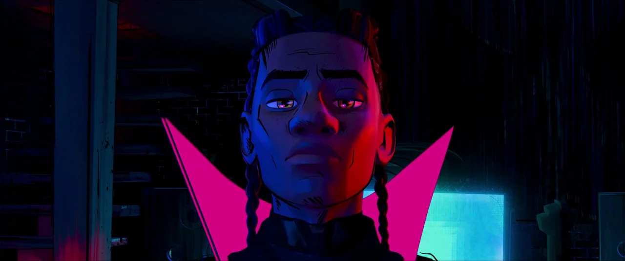 Spider-Man: Across the Spider-Verse (2023) movie still: closeup — A dark indoor space with a brick wall and a glowing cyan screen background. A…