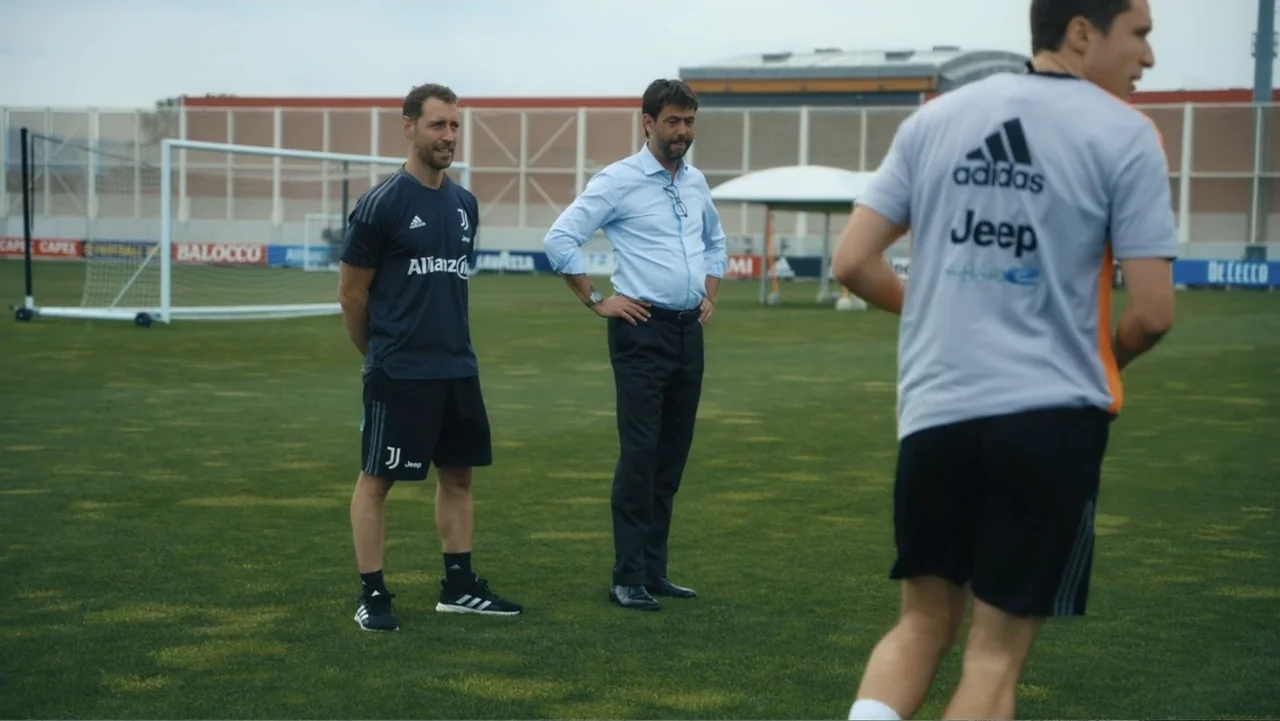 Federico Chiesa - Back on Track (2023) movie still: fullbody — A professional grass soccer training field features a white goal net in background.…