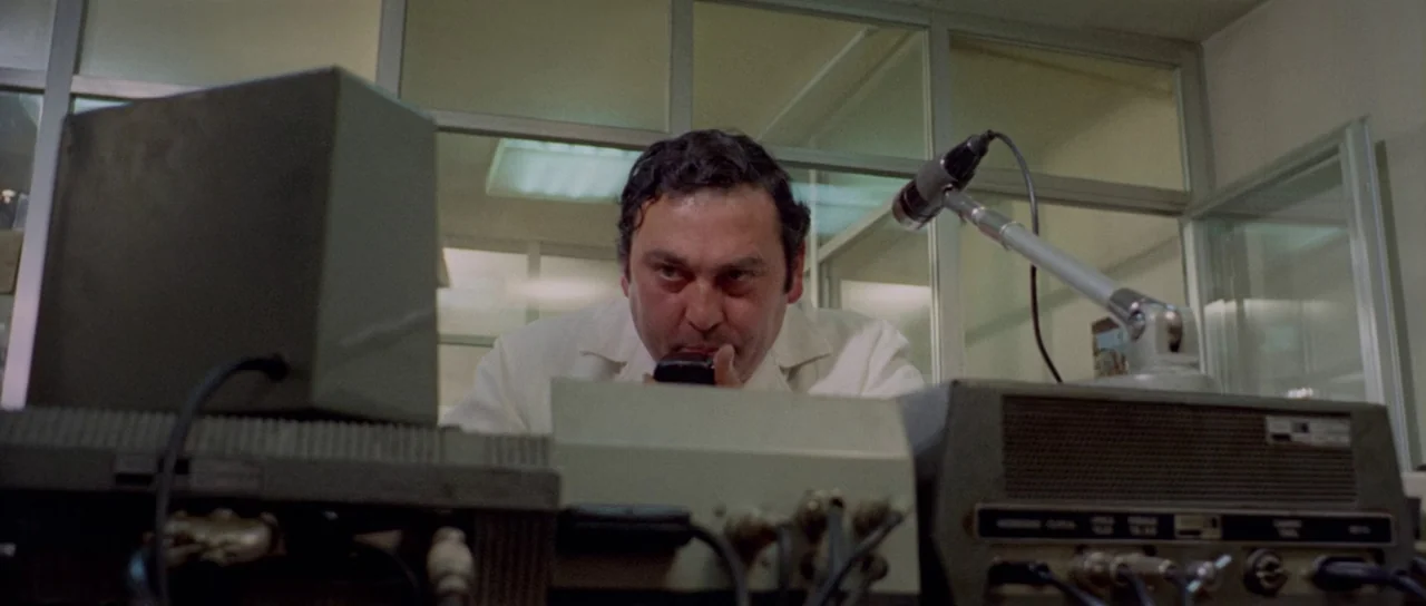 What Have They Done To Your Daughters? (1974) movie still: medium — An interior control room features glass partitions and various electronic…
