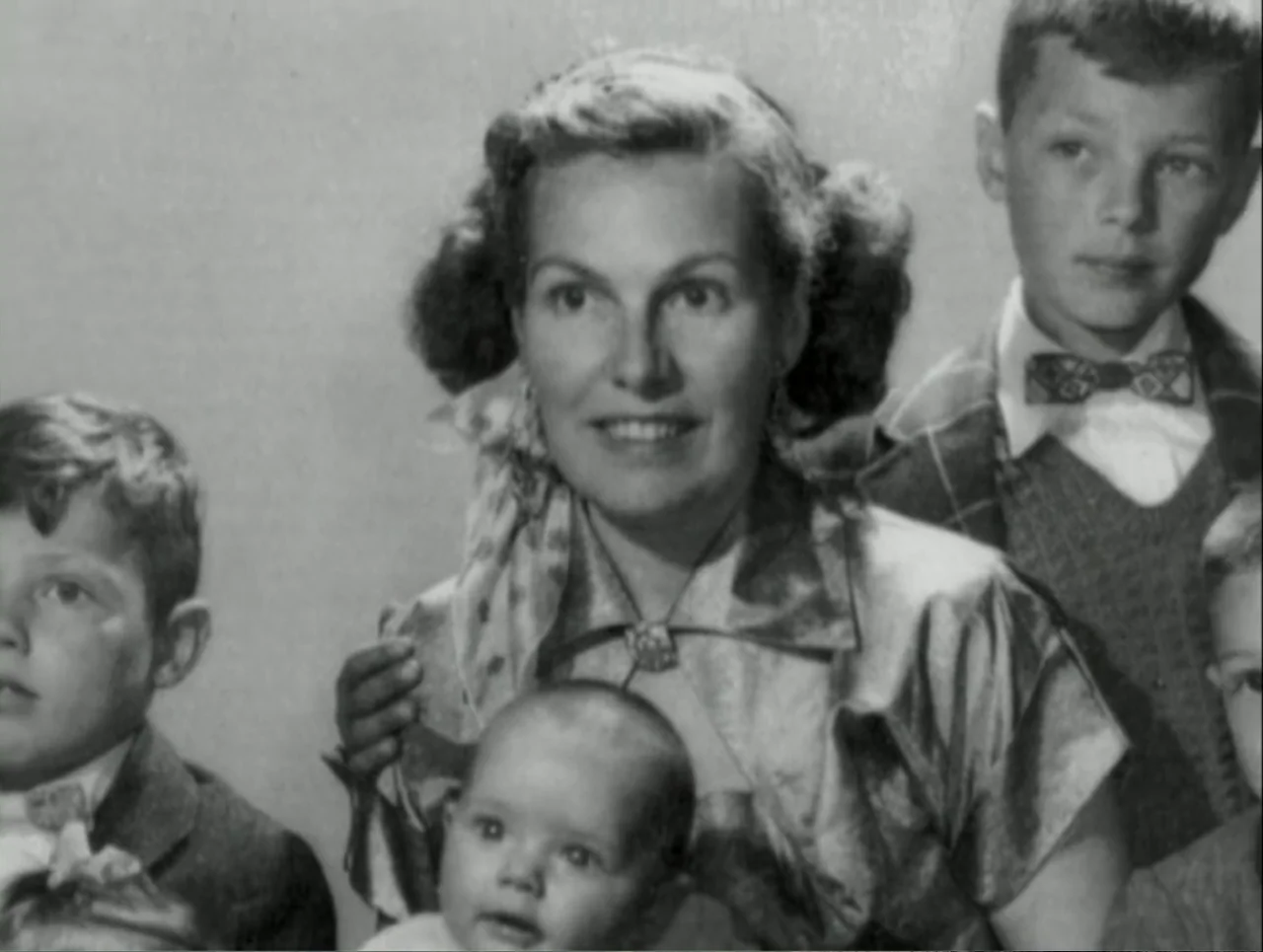 A Rape in a Small Town: The Florence Holway Story (2005) movie still: medium — A studio portrait featuring a mother and four children posed…