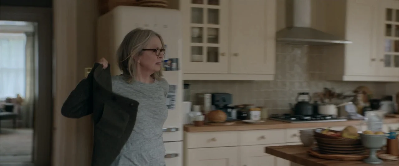 Hampstead (2017) movie still: medium — A residential kitchen features cream-colored cabinetry, a retro refrigerator, and a wooden countertop. A…