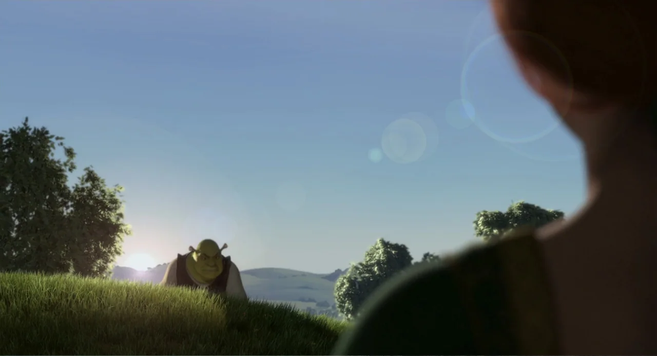 Shrek (2001) movie still: wide — An outdoor grassy hillside during golden hour with a distant view of rolling terrain. An ogre stands near the top…